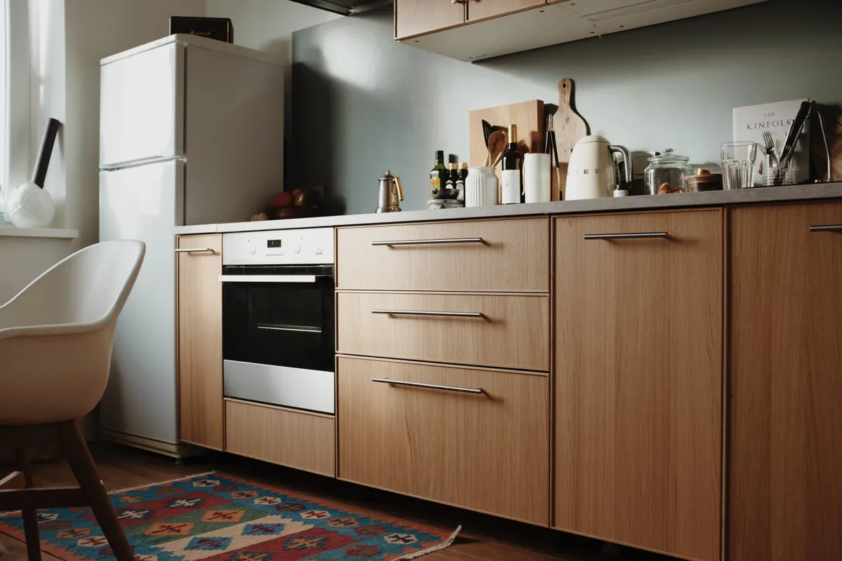 Cocina moderna y bonita con muebles de madera lisos y electrodomésticos